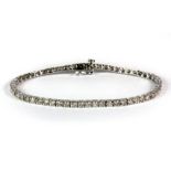 A 9ct white gold diamond line bracelet set with approx. 4ct of brilliant cut diamonds.