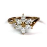 A pretty 9ct yellow gold stone set flower shaped ring (O.5).