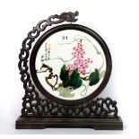 A hand painted Chinese porcelain panel mounted in a revolving carved hardwood frame, H. 31cm.