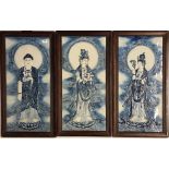 A set of three framed Chinese hand painted porcelain panels, featuring the Buddha flanked by two