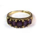 A 9ct yellow gold ring set with five oval cut amethysts (Q.5).