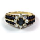 A yellow metal (tested minimum 9ct gold) sapphire and diamond set ring (S).