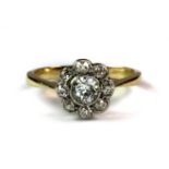 A yellow metal (tested 18ct gold) diamond daisy cluster ring (J.5).