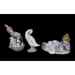 Two Lladro figures of a girl with a dog and a girl with ducks, together with a Lladro figure of a