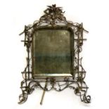 A large ornate 19th century white metal free standing mirror decorated with birds among bamboo and