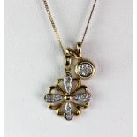 Two 9ct yellow and white gold diamond set pendants in a 9ct gold chain.