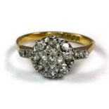 An 18ct yellow and white gold diamond set ring (M).