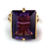 A yellow metal (tested 18ct gold) ring set with a large scissor cut synthetic alexandrite (P).