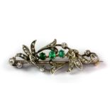 A lovely white metal (tested minimum 9ct gold) brooch set with rose cut diamonds and emeralds, L.