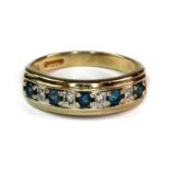 A 9ct yellow and white gold blue topaz and diamond half eternity ring (P).