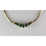 An 18ct yellow gold (stamped 18K) emerald and diamond set necklace.