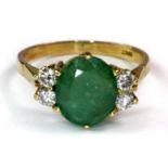 An 18ct yellow gold (stamped 18ct) ring set with an oval cut emerald and diamonds (S).