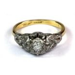 An 18ct yellow gold and platinum (tested) diamond set ring (N).