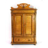 An early 20th century wall mounted oak cabinet, H. 61cm, W. 38cm, D. 15cm.