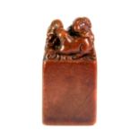 A Chinese red hardstone seal mounted with rats, H. 6.5cm.