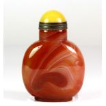 A Chinese banded agate snuff bottle with gilt yellow hardstone stopper, H. 7cm.