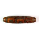 A Tibetan carved hardstone tzi bead, L. 9cm.