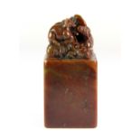 A Chinese mixed colour soapstone seal mounted with rats, H. 7cm.