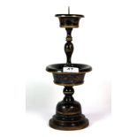 A late Qing dynasty Chinese turned and lacquered wood candlestick, H. 32cm.