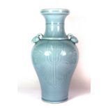 A lovely Chinese incised and pale blue glazed porcelain vase with goat head handles, H. 36cm, six