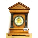 A 19th century oak classical mantle clock, H. 30cm.