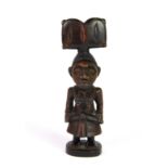 A small Yoruba carved wooden fertility shrine doll with coloured pigment decoration; Prov: Private