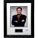 A framed signed photograph of Tom Jones.