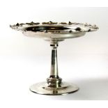 A George V hallmarked silver tazza, with pie crust style rim raised on a circular domed foot,