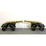 A pair of 19thC cast iron and brass model canons, L. 45cm.