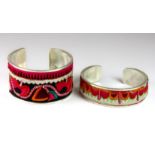 Two white metal mounted arm bangles set with Chinese tribal embroideries.