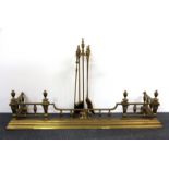 An ornate Victorian brass fender, W. 141cm together with a brass companion set.