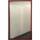 A large contemporary red lacquered bevelled glass mirror, 130cm x 73cm.