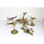 Five metal desk models of various aircraft.