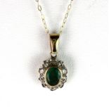 A 9ct yellow gold emerald and diamond cluster pendant on a 9ct chain, L. 2cm.