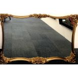 A large gilt framed hanging wall mirror, 128cm x 83cm.