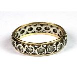 A 9ct yellow and white gold (worn mark 9ct) stone set full eternity ring (M.5).