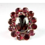 A stunning Georgian yellow metal (tested minimum 9ct gold) cluster ring set with garnets (O).