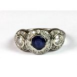 A 14ct white gold (stamped 14k) sapphire and diamond set triple halo ring with diamond set shoulders