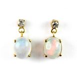 A pair of yellow metal (tested 18ct gold) opal and diamond set drop earrings, L. 2cm.