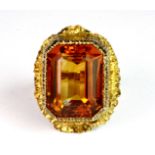 An impressive 9ct yellow gold (stamped 9ct) ring set with a large emerald cut orange citrine (L.5).