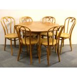 A circular table together with a set of six cane and bentwood chairs.