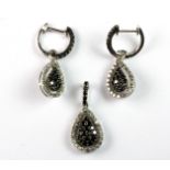 A 10ct white gold (stamped 10k) set of pendant and matching drop earrings set with black and white