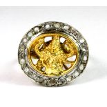 A 9ct yellow and white gold ring depicting an image of Garuda surrounded by diamonds (M.5).