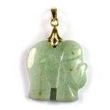 A yellow metal mounted carved jade elephant pendant, L. 4cm.