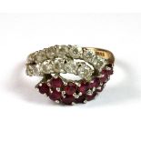 A 9ct yellow gold ruby and white stone set ring (K).