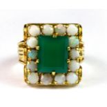 A heavy yellow metal (tested 18ct yellow gold) ring set with an emerald cut nephrite surrounded by