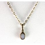 A 9ct yellow gold (stamped 375) diamond and opal pendant and chain, L. 0.8cm.