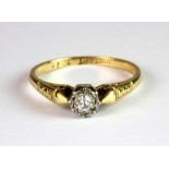 An 18ct gold and platinum (stamped 18ct & plat) diamond solitaire ring (K.5).