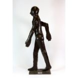 A contemporary painted steel sculpture of a walking figure, H. 61cm.