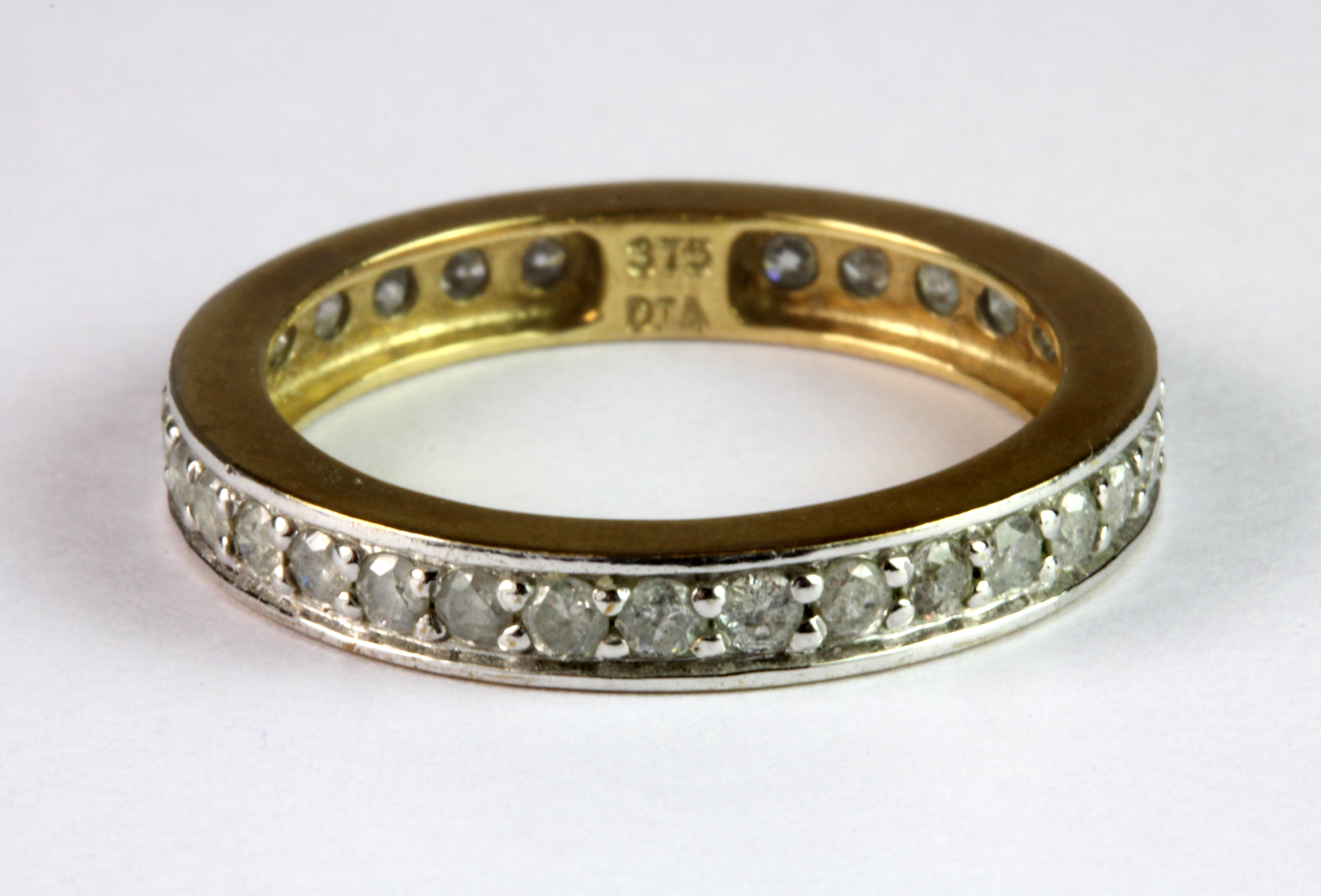 A 9ct yellow gold (stamped 375) diamond set full eternity ring.